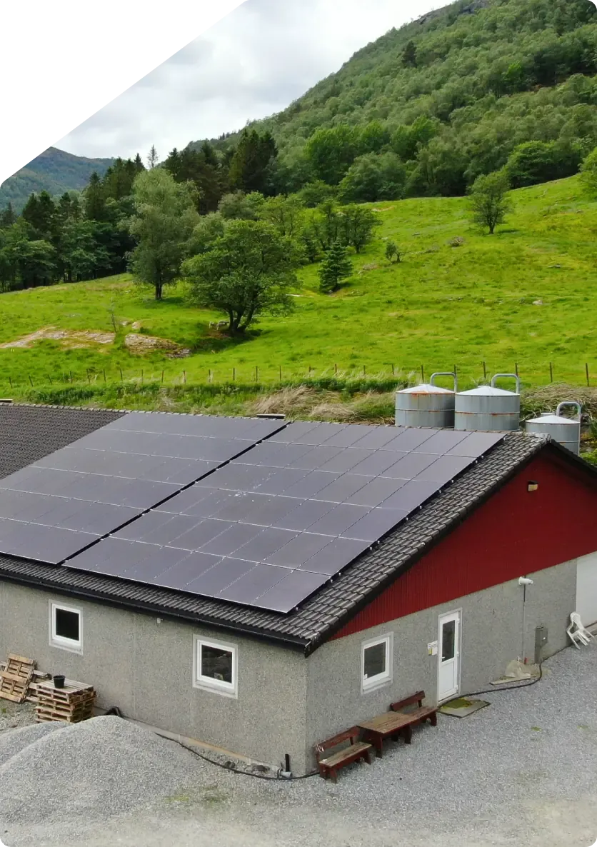 Farm building with solar panels mounted on the roof.