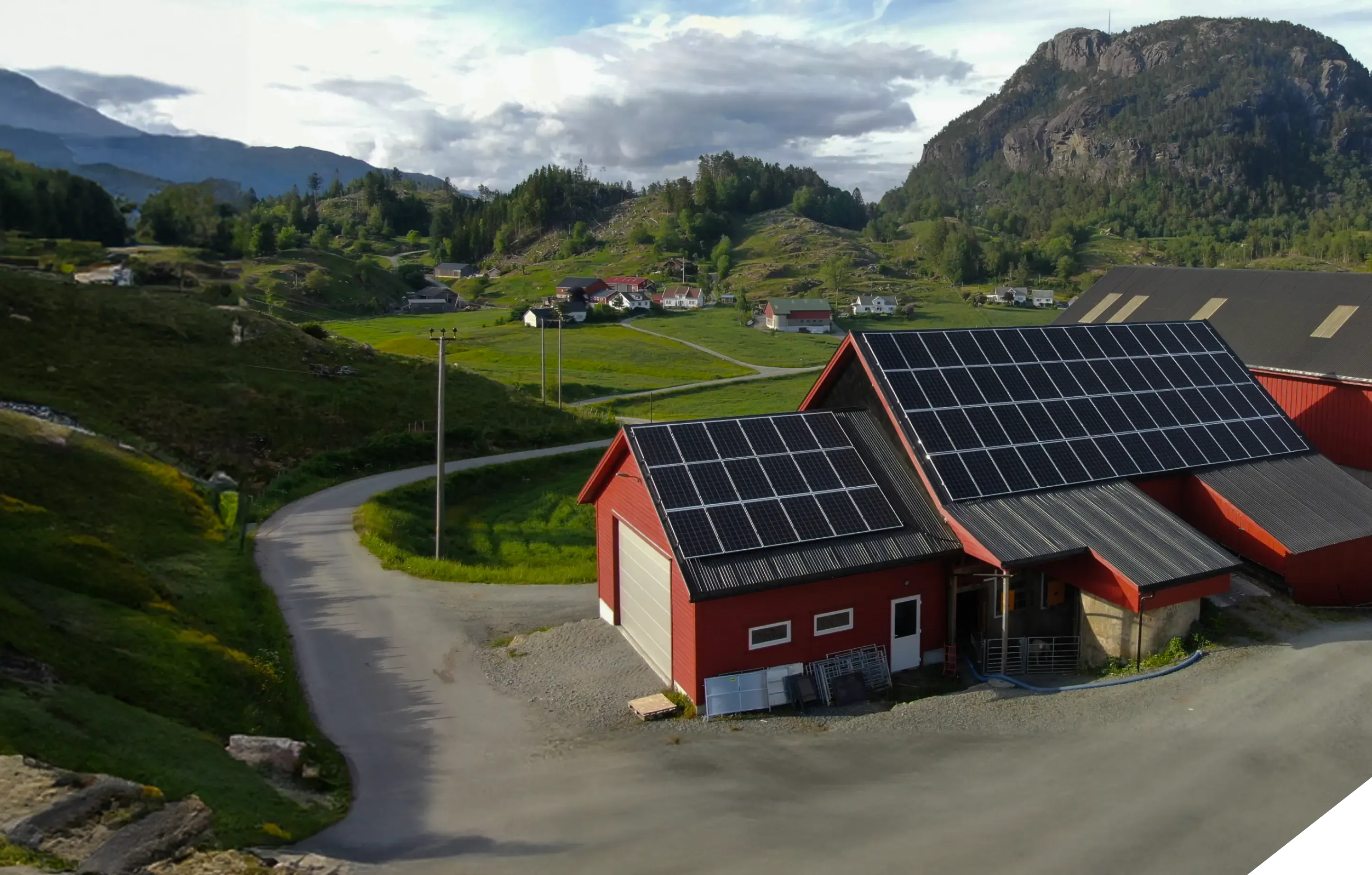 Red barn with solar panels on the roof.