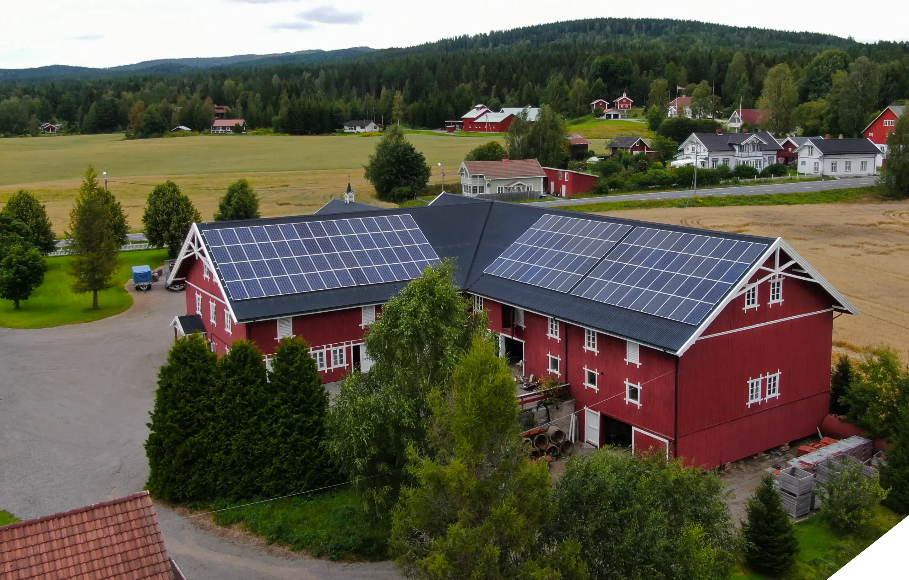 Red farmhouse with solar panels across the whole roof.